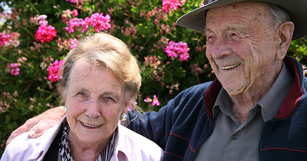 Older couple standing in garden